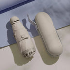 Beige mini capsule umbrella with compact carrying case