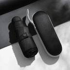 Black mini capsule umbrella with compact carrying case