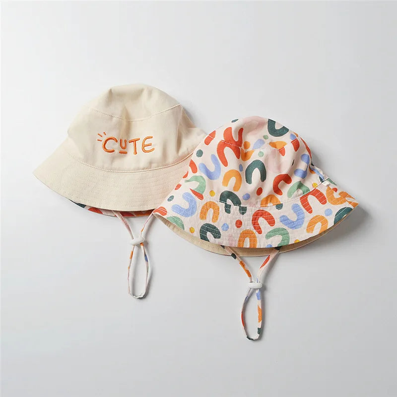 Kids reversible cotton bucket hat showing both wearable designs