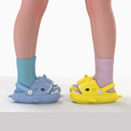 Kids wearing colorful 2-in-1 shark sandals with adjustable heel straps