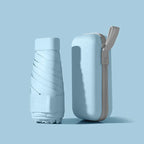 Light blue mini pocket umbrella with protective capsule
