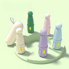 Mini capsule umbrellas in multiple colors with compact carrying cases