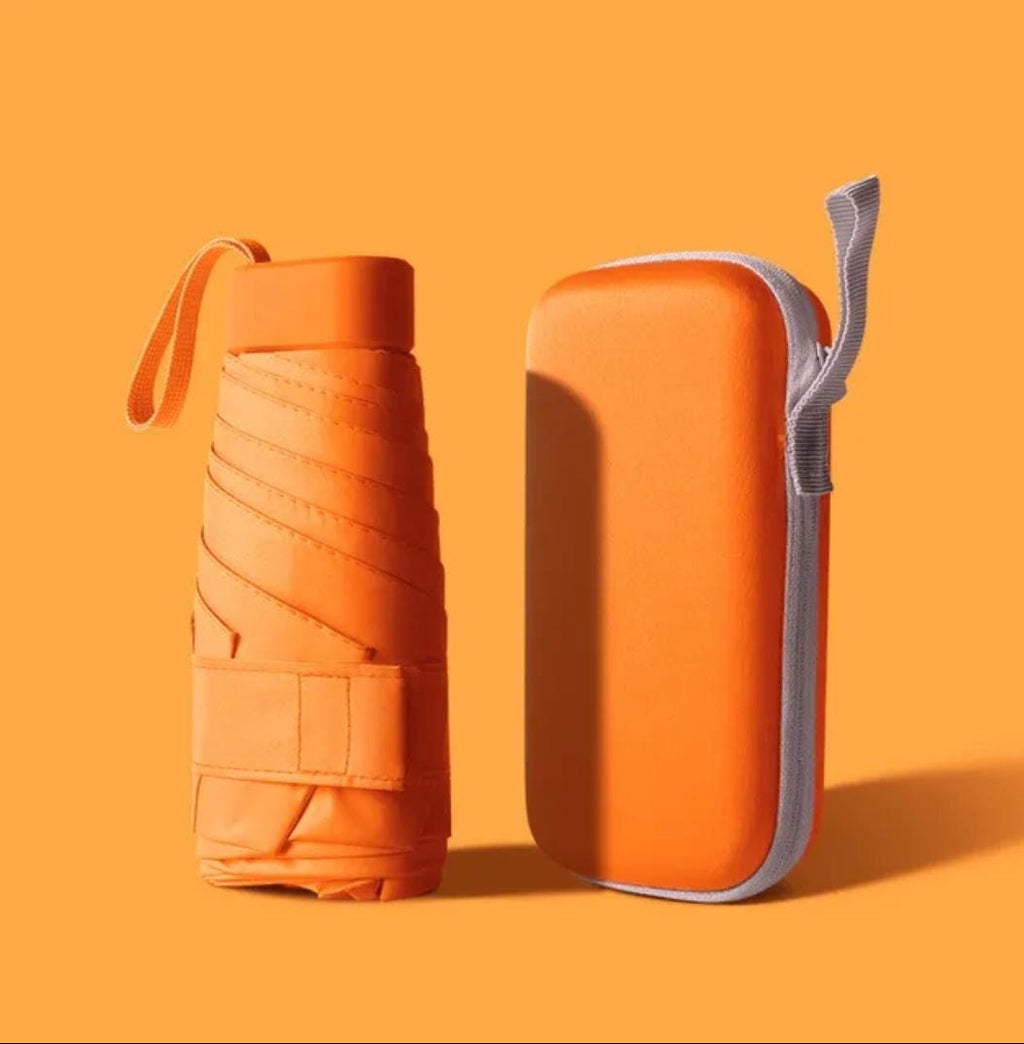 Orange mini pocket umbrella with protective capsule