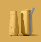 Yellow mini pocket umbrella with protective capsule