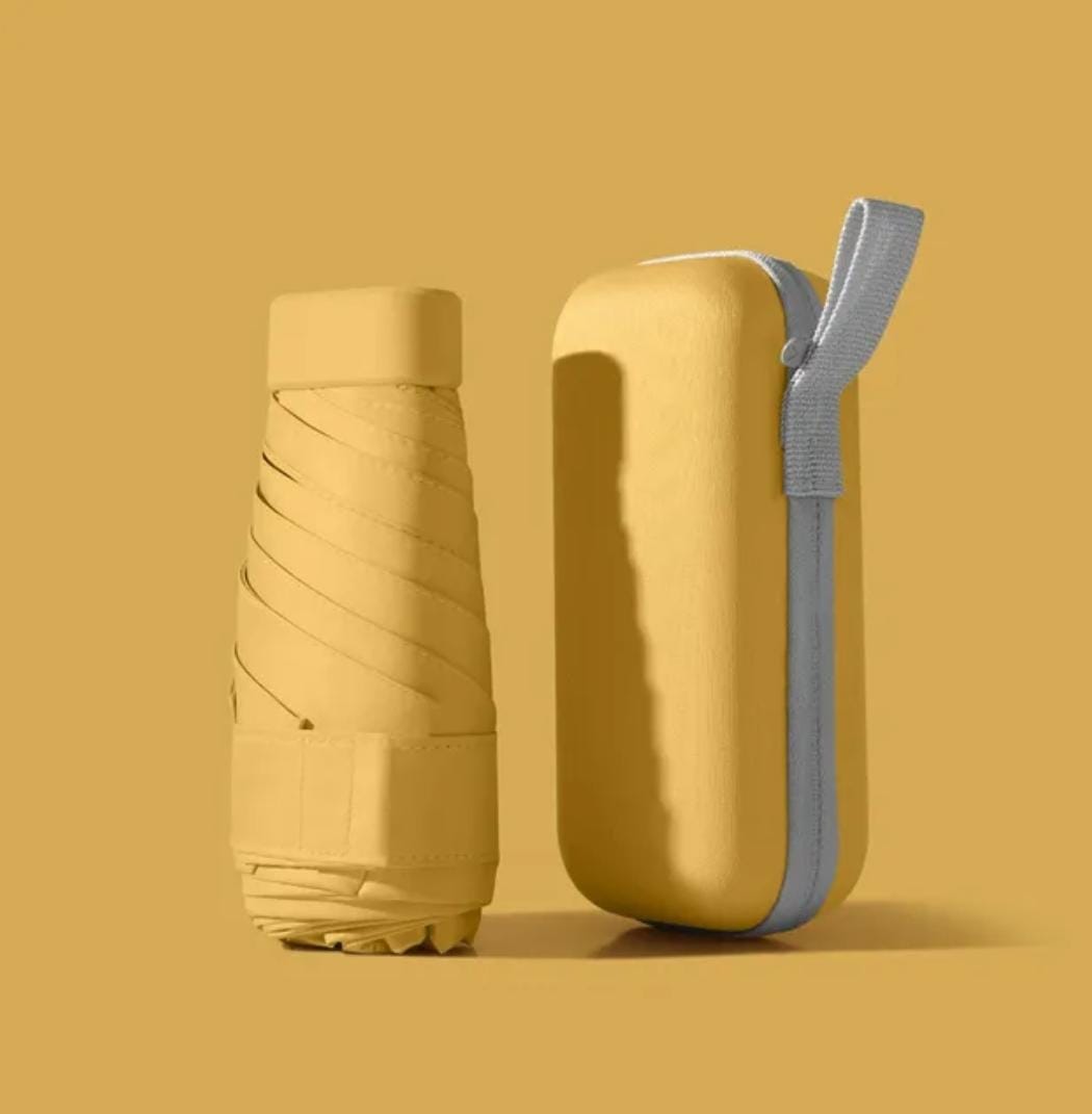 Yellow mini pocket umbrella with protective capsule